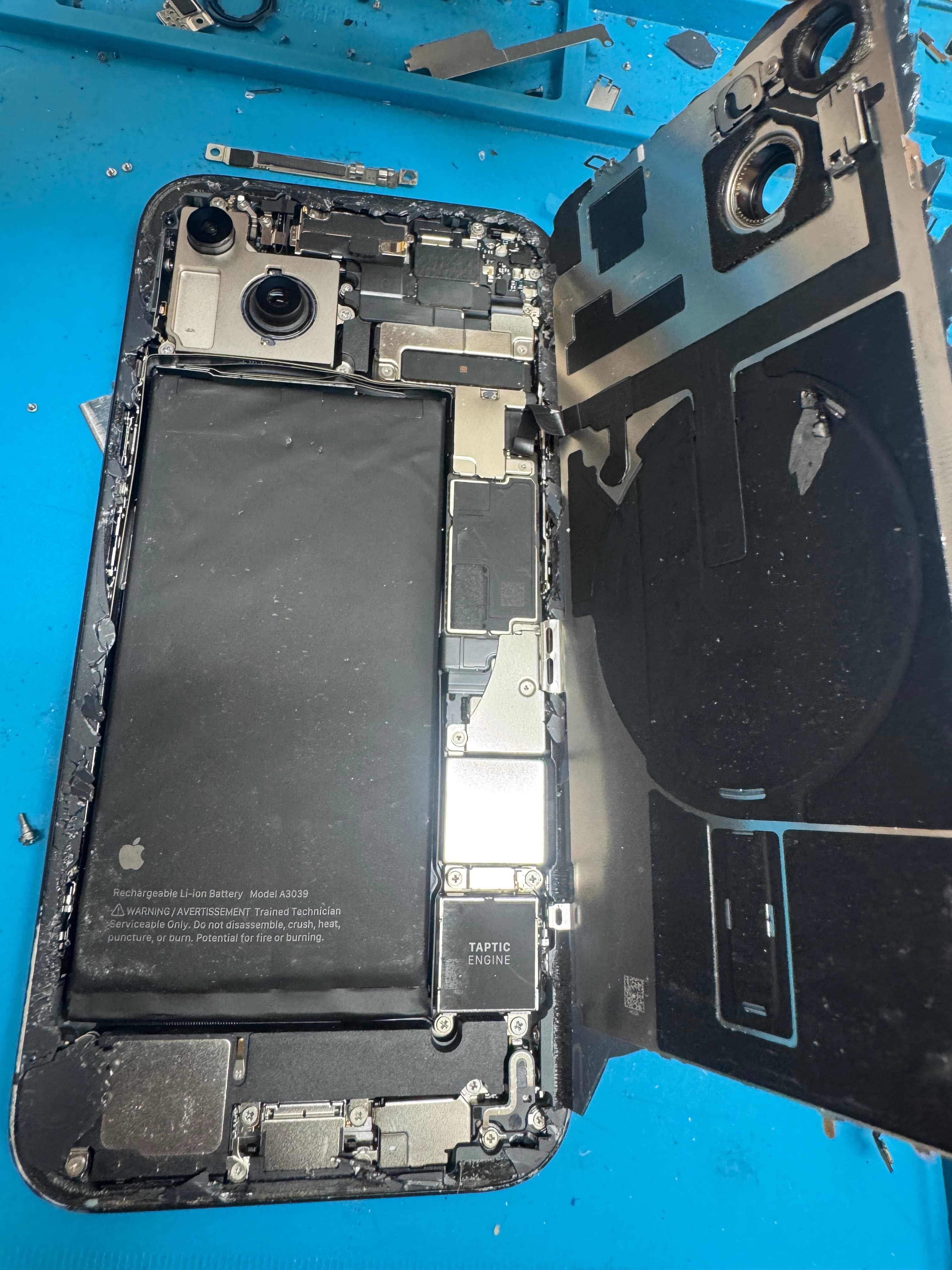Open iPhone on the KINGSELL bench with the battery still in the chassis